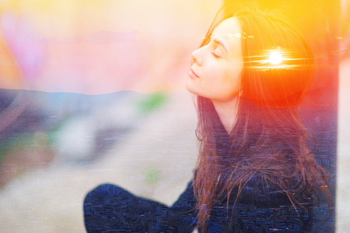 Double multiply exposure portrait of a dreamy cute woman meditating outdoors with eyes closed, combined with photograph of nature, sunrise or sunset. closeup. Psychology power of mind concept.
